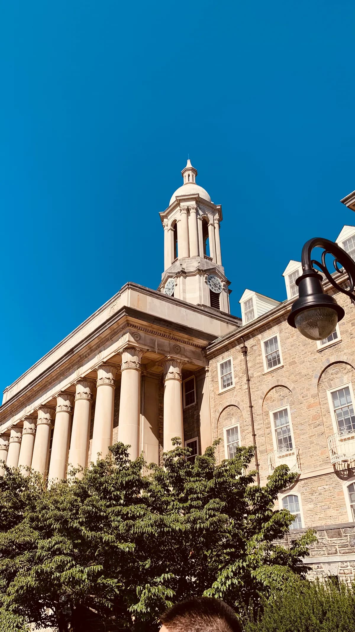 Penn State's Old Main under a blue sky